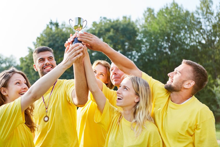 Happy,Winners,Team,Proudly,Holds,The,Trophy,High,In,The Happy Winners Team proudly holds the trophy high in the Teambuilding Event